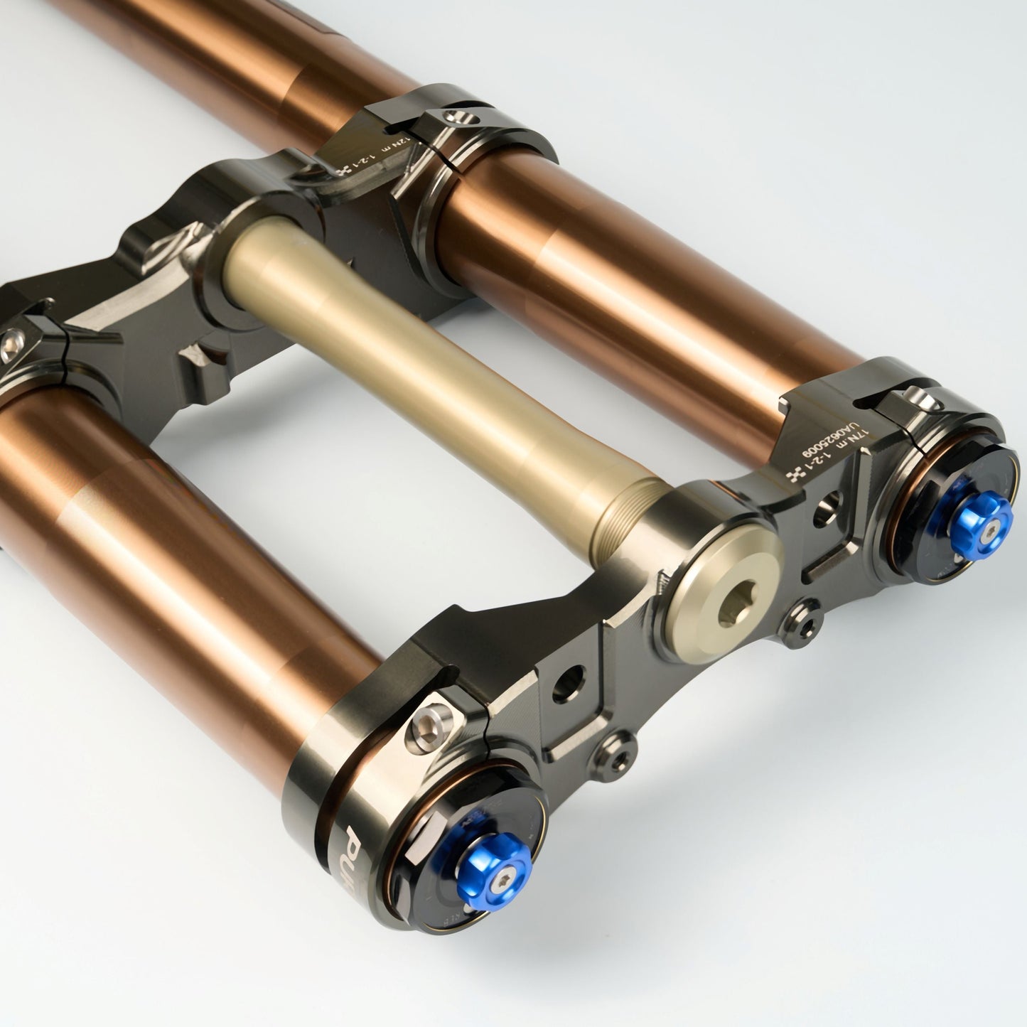Close-up of a metallic suspension fork on a white background