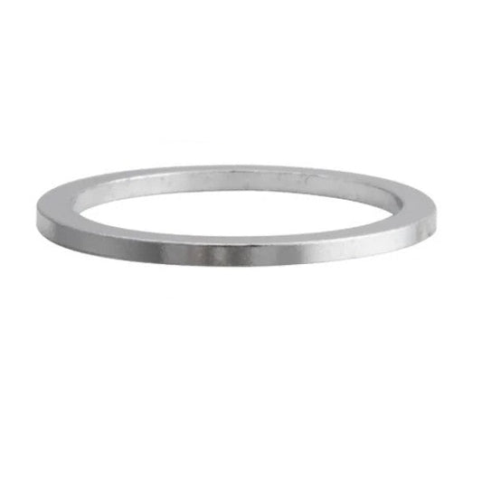 Four metallic washers of different sizes on a white background