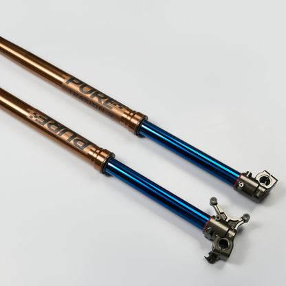 Two metal suspension forks, one blue and one bronze, on a white background.