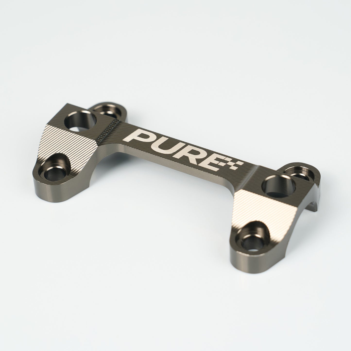 Metallic component with 'PURE' branding on a white background