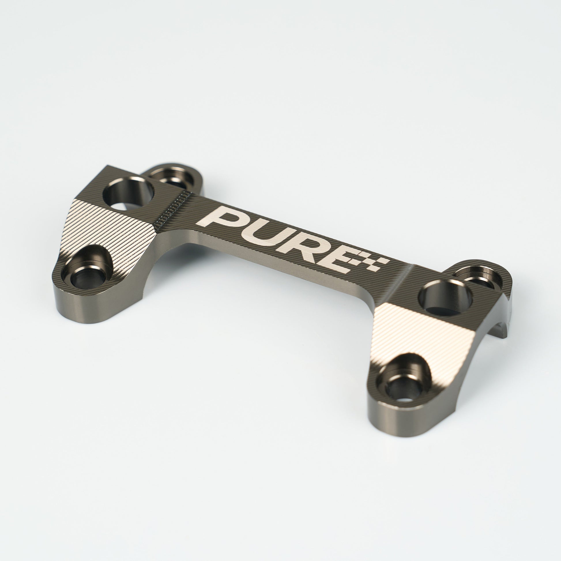 Metallic component with 'PURE' branding on a white background