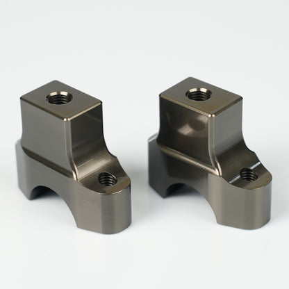 Two metallic mechanical components on a white background